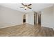 Spacious main bedroom with wood-look floors, neutral paint, and a ceiling fan for added comfort at 213 Primrose Dr, Davenport, FL 33837