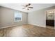 Bedroom with wood-look floors and a view of the ensuite bathroom with granite counters at 213 Primrose Dr, Davenport, FL 33837