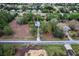An aerial view of a property with a long driveway and surrounding trees at 21311 Sw Marine Blvd, Dunnellon, FL 34431