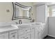 Bathroom featuring double sinks, a large mirror, and modern fixtures for a bright and spacious feel at 21311 Sw Marine Blvd, Dunnellon, FL 34431