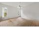 Spacious bedroom with a ceiling fan and two windows offering natural light, carpeted floor, blank walls at 21311 Sw Marine Blvd, Dunnellon, FL 34431