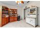 Well-lit bedroom featuring a ceiling fan and multiple bookshelves, offering ample storage at 21311 Sw Marine Blvd, Dunnellon, FL 34431