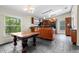 Dining room and kitchen with tile floors, wooden cabinetry, and a large window at 21311 Sw Marine Blvd, Dunnellon, FL 34431