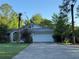 Two-story home featuring an attached two-car garage and a well-maintained front yard at 21311 Sw Marine Blvd, Dunnellon, FL 34431