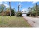 Charming single-Gathering home with a two-car garage, lush landscaping, and a paved driveway at 21311 Sw Marine Blvd, Dunnellon, FL 34431