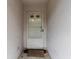 A classic white front door with glass panels welcomes visitors to the home's entrance at 21311 Sw Marine Blvd, Dunnellon, FL 34431