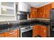 Kitchen featuring a mosaic backsplash, wood cabinetry, and a stainless steel oven at 21311 Sw Marine Blvd, Dunnellon, FL 34431