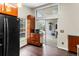 Kitchen area with wood cabinets, access to the lanai and a black refrigerator at 21311 Sw Marine Blvd, Dunnellon, FL 34431