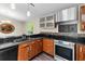 Kitchen with a stainless steel oven, modern cabinetry, and mosaic backsplash at 21311 Sw Marine Blvd, Dunnellon, FL 34431