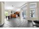Bright living room with gray tile flooring, views into the kitchen and access to the lanai at 21311 Sw Marine Blvd, Dunnellon, FL 34431