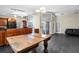 Spacious living area with kitchen access, gray tile flooring, and slider door to lanai at 21311 Sw Marine Blvd, Dunnellon, FL 34431