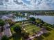 Aerial view of clubhouse, pool, bocce ball, and gathering areas with lake in background at 2174 Wallingford Loop, Mount Dora, FL 32757