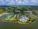 Drone view of resort-style amenities including community center, pool, and tennis courts at 2174 Wallingford Loop, Mount Dora, FL 32757