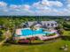 Aerial of community center, swimming pool and lush landscaping in a beautiful community at 2174 Wallingford Loop, Mount Dora, FL 32757