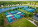 Aerial view of multi-use recreation park featuring tennis and pickle ball courts at 2174 Wallingford Loop, Mount Dora, FL 32757