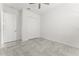 Neutral bedroom with tile flooring, ceiling fan, and closet space at 2174 Wallingford Loop, Mount Dora, FL 32757