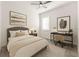 Cozy bedroom features a comfortable bed, modern desk, and bright natural light at 2174 Wallingford Loop, Mount Dora, FL 32757