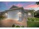 Charming single story home with two car garage, stone accents, and landscaped yard at 2174 Wallingford Loop, Mount Dora, FL 32757