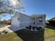 Charming home exterior with a two car garage, stylish stone accents, and a well-manicured lawn at 2174 Wallingford Loop, Mount Dora, FL 32757