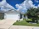 Beautiful single Gathering home with well-kept landscaping, a two-car garage, and stone facade accents at 2174 Wallingford Loop, Mount Dora, FL 32757