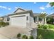 Well-maintained single-Gathering home with a two-car garage, charming entryway, and landscaped front yard at 2174 Wallingford Loop, Mount Dora, FL 32757