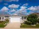 Beautiful single-story home with a two-car garage, stone accents, and professionally landscaped front yard at 2174 Wallingford Loop, Mount Dora, FL 32757