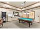 Bright game room with a pool table, dart board, wall art, and comfortable seating for friendly competition at 2174 Wallingford Loop, Mount Dora, FL 32757