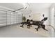 Spacious garage converted into a home gym with exercise equipment and modern decor at 2174 Wallingford Loop, Mount Dora, FL 32757