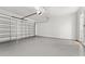 Spacious two car garage with gray floor and white block walls at 2174 Wallingford Loop, Mount Dora, FL 32757