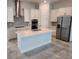 Modern kitchen with stainless steel appliances, granite countertops, island, and white cabinetry at 2174 Wallingford Loop, Mount Dora, FL 32757