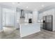 Bright, spacious kitchen features stainless appliances, subway tile backsplash, and large island at 2174 Wallingford Loop, Mount Dora, FL 32757