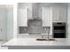Modern kitchen with stainless steel appliances, sleek backsplash, and ample counter space at 2174 Wallingford Loop, Mount Dora, FL 32757