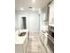 Kitchen featuring stainless steel appliances, white cabinets, and quartz countertops at 2174 Wallingford Loop, Mount Dora, FL 32757