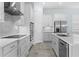 Modern kitchen with stainless steel appliances, white cabinetry, subway tile backsplash, and ample counter space at 2174 Wallingford Loop, Mount Dora, FL 32757