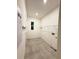 Bright laundry room with tile floor, shelving, and modern amenities at 2174 Wallingford Loop, Mount Dora, FL 32757