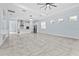 Expansive living room with tile floors, recessed lighting, and ample natural light at 2174 Wallingford Loop, Mount Dora, FL 32757