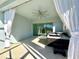 Relaxing screened patio with a fan, curtains, hot tub, and sliding glass doors at 2174 Wallingford Loop, Mount Dora, FL 32757