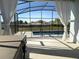 Charming screened patio view showcasing the pool with a safety fence at 2174 Wallingford Loop, Mount Dora, FL 32757