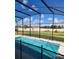 Backyard pool with screened enclosure, providing a private outdoor retreat in a lush green setting at 2174 Wallingford Loop, Mount Dora, FL 32757