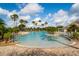 Beautiful zero entry pool surrounded by lush tropical landscaping and comfortable lounge chairs provides relaxation at 2174 Wallingford Loop, Mount Dora, FL 32757