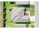 Overhead view of a house with a well-kept roof, manicured lawn, and neatly arranged landscaping at 2188 Gordon Path, The Villages, FL 32163