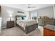 Comfortable bedroom featuring a decorative bed frame, ample closet space, and a large window for natural light at 2188 Gordon Path, The Villages, FL 32163