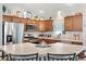 Bright kitchen with a large island, stainless steel appliances, ample cabinetry, and pendant lighting at 2188 Gordon Path, The Villages, FL 32163