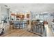 Spacious kitchen with a breakfast bar, wood cabinets, stainless steel appliances, and an adjacent dining area at 2188 Gordon Path, The Villages, FL 32163