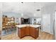 Bright eat-in kitchen featuring a center island with pendant lighting, ample storage and views of the dining area at 2188 Gordon Path, The Villages, FL 32163