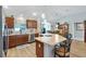 Spacious kitchen featuring an island with countertop seating, wood cabinets, and stainless steel appliances at 2188 Gordon Path, The Villages, FL 32163