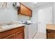 Bright laundry room featuring modern washer/dryer, cabinets, and sink at 2188 Gordon Path, The Villages, FL 32163