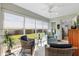 Bright sunroom featuring comfortable seating, windows with backyard views, and an abundance of natural light at 2188 Gordon Path, The Villages, FL 32163