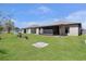 Expansive backyard with lush green grass, screened-in lanai, and well-maintained landscaping at 2376 Bexley Dr, Tavares, FL 32778