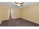 Neutral bedroom featuring plush brown carpet, a ceiling fan, and an open doorway to a closet at 2376 Bexley Dr, Tavares, FL 32778